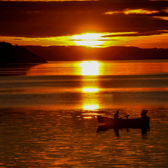 Disfrutando de un atardecer dorado en bote en las tranquilas aguas del lago cerca de Pucón